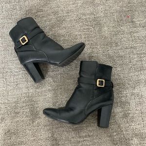 Black faux leather booties with gold accent